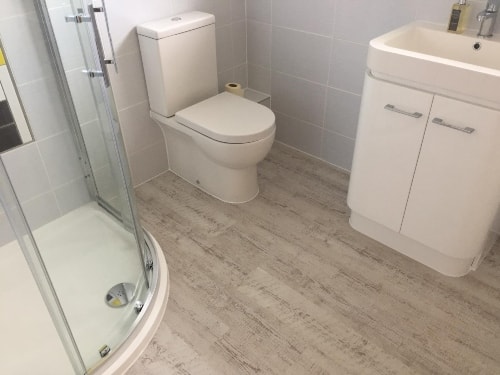 pale wooden floor in bathroom